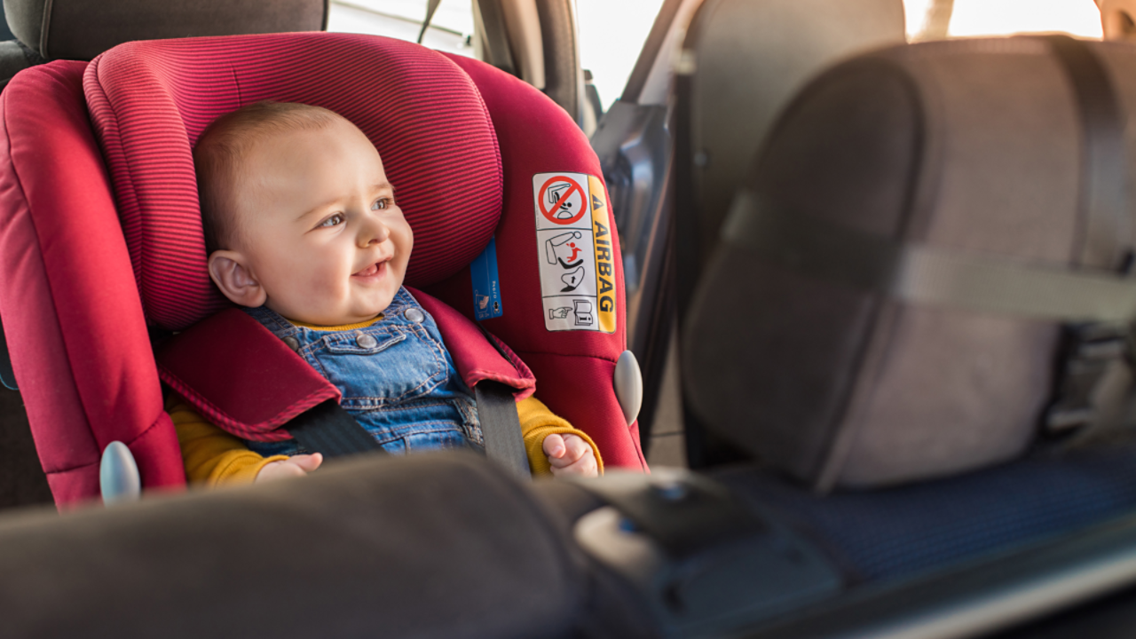 Smiling baby in backseat 